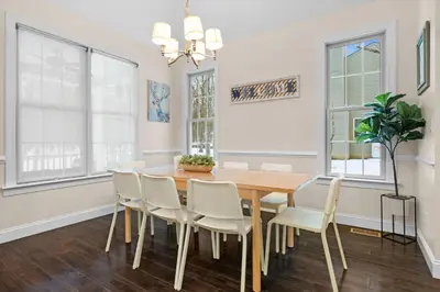 a dining room with a wooden table and white chairs at Hot Tub Game Room Spacious Close to Skiing in Albrightsville