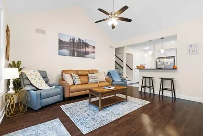 a living room with a couch and a table at Hot Tub Game Room Spacious Close to Skiing in Albrightsville