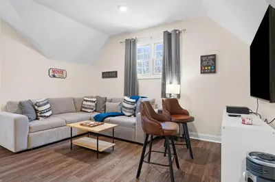 a living room with a couch and a table at Hot Tub Game Room Spacious Close to Skiing in Albrightsville