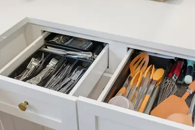 a white kitchen drawer filled with utensils at Monster-themed lake front cabin with firepit sauna hot tub game room in Tobyhanna
