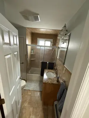 a bathroom with a sink and a toilet and a mirror at Apartment 2 BR near NYC 5min from EWR & 20min from MetLife in Elizabeth