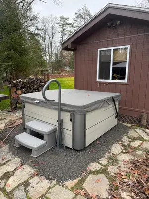 a large hot tub sitting outside of a house at Serenity at Moon Lake Hot Tub Sauna Massage in Ashland