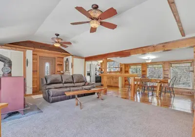 a living room with a couch and a table at Serenity at Moon Lake Hot Tub Sauna Massage in Ashland