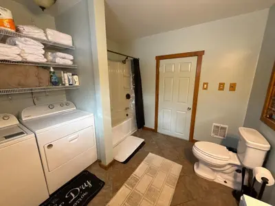 a bathroom with a toilet and a sink and a shower at Serenity at Moon Lake Hot Tub Sauna Massage in Ashland