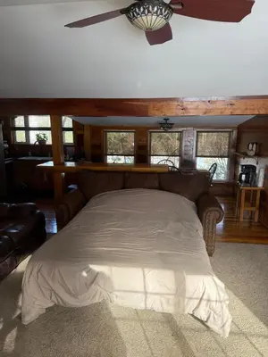 a bedroom with a bed in a room with windows at Serenity at Moon Lake Hot Tub Sauna Massage in Ashland