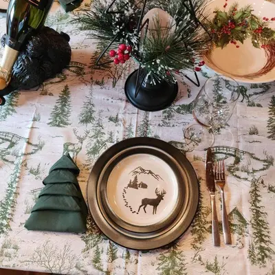 a table with a plate and a christmas tree on it at Authentic Log Cabin Short walk to Lake & Hideout in Lake Ariel