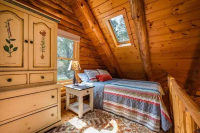 a bedroom with a bed in a log cabin at Authentic Log Cabin Short walk to Lake & Hideout in Lake Ariel