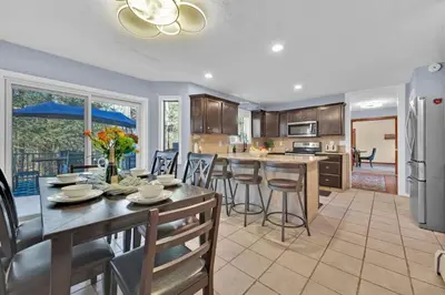 a kitchen and dining room with a table and chairs at Big Bass Hideaway with Hot Tub in Gouldsboro