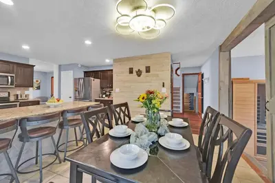 a dining room and kitchen with a table and chairs at Big Bass Hideaway with Hot Tub in Gouldsboro