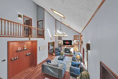 a living room with a couch and a table at Big Bass Hideaway with Hot Tub in Gouldsboro