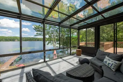 a living room with a view of a lake at Lakefront Big Bass Lake Dock Games in Gouldsboro