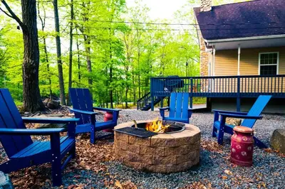 a fire pit with two blue chairs and a fire hydrant at 4BDRM Games Family Frndly Fire Pit Masthope in Lackawaxen