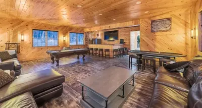 a living room with couches and ping pong tables at 6 Bedrooms Hot Tub Game Room Movie Theater in Hawley