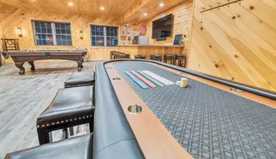 a game room with a ping pong table in a cabin at 6 Bedrooms Hot Tub Game Room Movie Theater in Hawley