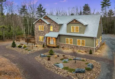 a large house with a gambrel roof at 6 Bedrooms Hot Tub Game Room Movie Theater in Hawley