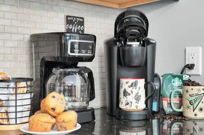 a counter with a coffee maker and a plate of muffins at Hot Tub Game Room Firepit Arrowhead Family in Thornhurst