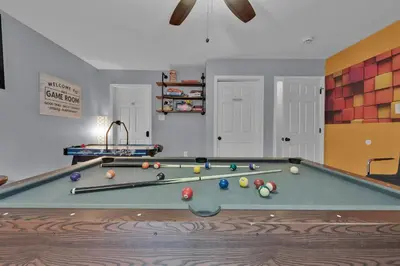 a room with a pool table with balls on it at Hot Tub Game Room Firepit Arrowhead Family in Thornhurst