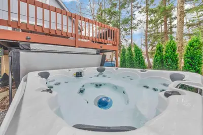 a jacuzzi tub in the backyard of a house at Lakefront Hot Tub Kayaks High End Peaceful in Tobyhanna