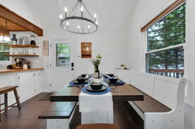a kitchen with a dining table and a dining room at Lakefront Hot Tub Kayaks High End Peaceful in Tobyhanna