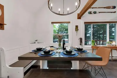 a kitchen with a dining room table with a dining room at Lakefront Hot Tub Kayaks High End Peaceful in Tobyhanna