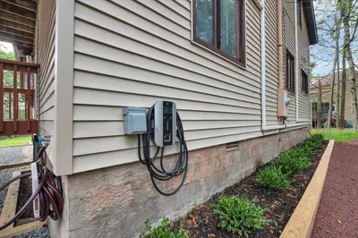 a house with a electricity meter on the side of it at Lakefront AC Pool Table Kayaks Refined in Tobyhanna