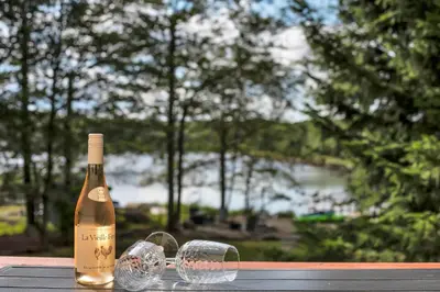 a bottle of champagne and two glasses on a table at Lakefront AC Pool Table Kayaks Refined in Tobyhanna