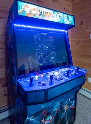 a video game console with a marvel movie on the screen at Massive Log Chalet with Hot Tub in Lakeville