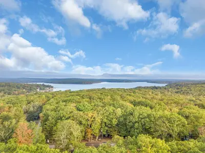 an aerial view of a lake in the forest at Charming Getaway Minutes from Lake Wallenpaupack in Tafton