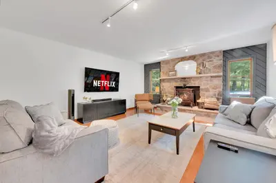 a living room with two couches and a fireplace at Charming Getaway Minutes from Lake Wallenpaupack in Tafton