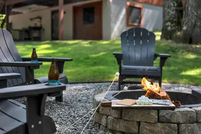 two chairs and a fire pit in a yard at Charming Getaway Minutes from Lake Wallenpaupack in Tafton