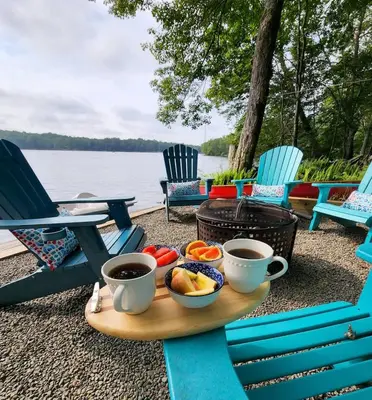 a tray of food on a table with two cups of coffee at Lakefront Hot Tub Canoes Game Room Wood FP in Gouldsboro