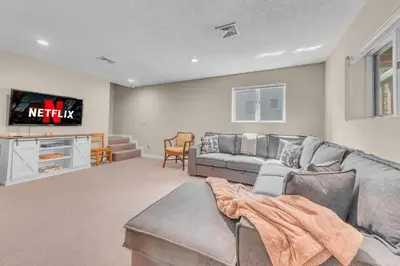 a living room with a couch and a tv at Large Family Friendly House on the Fairway Hideout in Lakeville