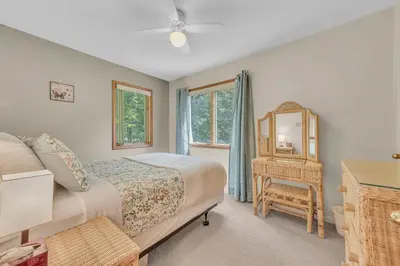 a bedroom with a bed and a mirror and a chair at Large Family Friendly House on the Fairway Hideout in Lakeville