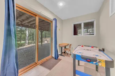 a room with a bed and a sliding glass door at Large Family Friendly House on the Fairway Hideout in Lakeville