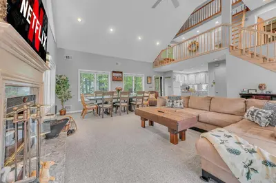 a living room with a couch and a table at Large Family Friendly House on the Fairway Hideout in Lakeville
