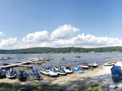 a group of boats parked on the shore of a lake at The Lookout Lake Masthope Firepit Arcade in Lackawaxen