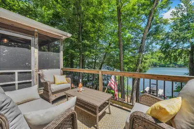 a screened in porch with a table and chairs at Lake Wallenpaupack Lakefront Private Boat Slip in Greentown