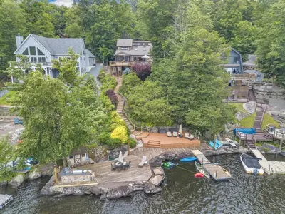 an aerial view of a house with a dock in the water at Lakefront Views 5 Bdrm Kayaks Out Kitchen in Lake Ariel