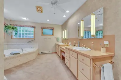 a large bathroom with a tub and a sink and a tubermott at Lakefront Views 5 Bdrm Kayaks Out Kitchen in Lake Ariel
