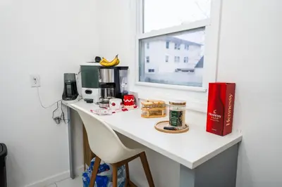 a counter in a kitchen with a table and a window at Linden Room in Linden