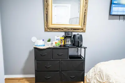 a black dresser with a mirror above it at Linden Room in Linden