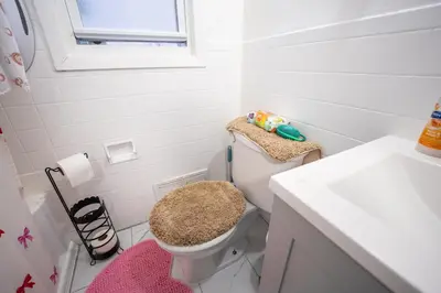a white bathroom with a toilet and a sink at Linden Room in Linden