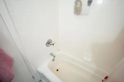 a bathroom with a white tub and a sink at Linden Room in Linden