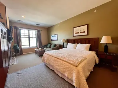 a bedroom with a large bed and a couch at The Appalachian at Mountain Creek in Vernon Township