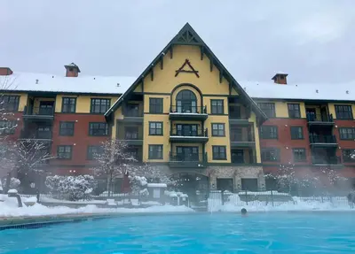 a building with a swimming pool in front of it at The Appalachian at Mountain Creek in Vernon Township