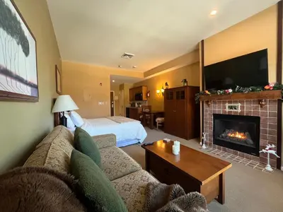 a living room with a couch and a fireplace at The Appalachian at Mountain Creek in Vernon Township