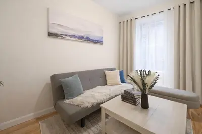 a living room with a couch and a table at Bright 3BD Unit Close to Columbia University & Central Park in New York