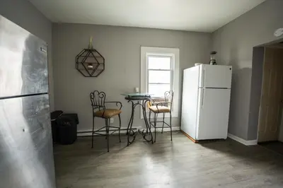 a kitchen with a table and a white refrigerator at Casa Ebenecer - Habitación privada # 1 in Elizabeth