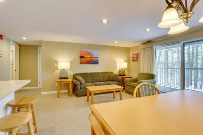 a living room with a couch and a table at All-Season Lake Wallenpaupack Condo with Views in Greentown