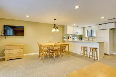 a kitchen and dining room with a table and chairs at All-Season Lake Wallenpaupack Condo with Views in Greentown